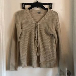 Beige knitted sweater.